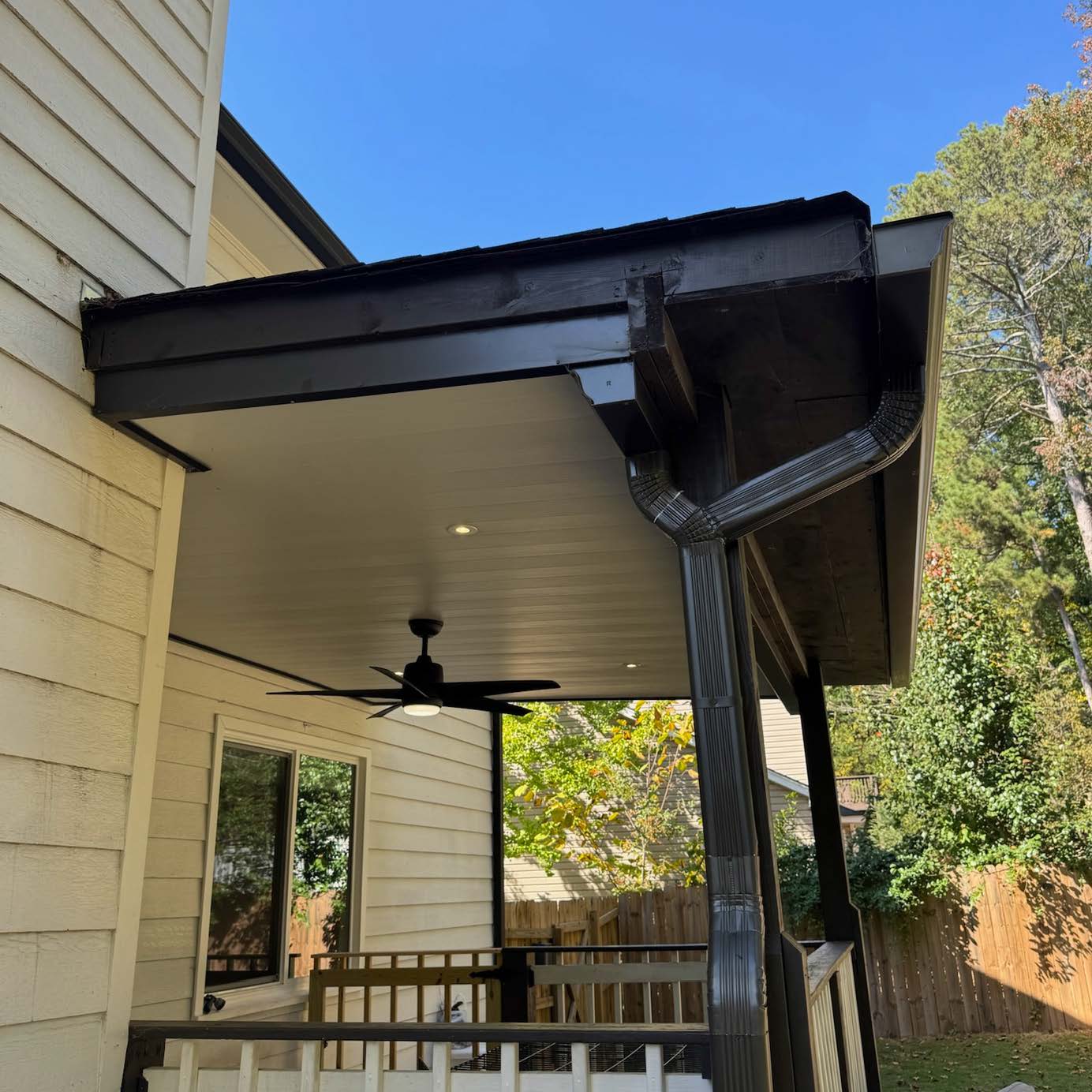 Georgia Luxe Outdoors professional covered deck renovation featuring a modern black trim finish and outdoor ceiling fan.