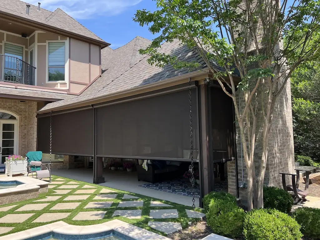 Georgia Luxe Outdoors exterior motorized retractable screens enclosing a backyard patio next to a swimming pool.